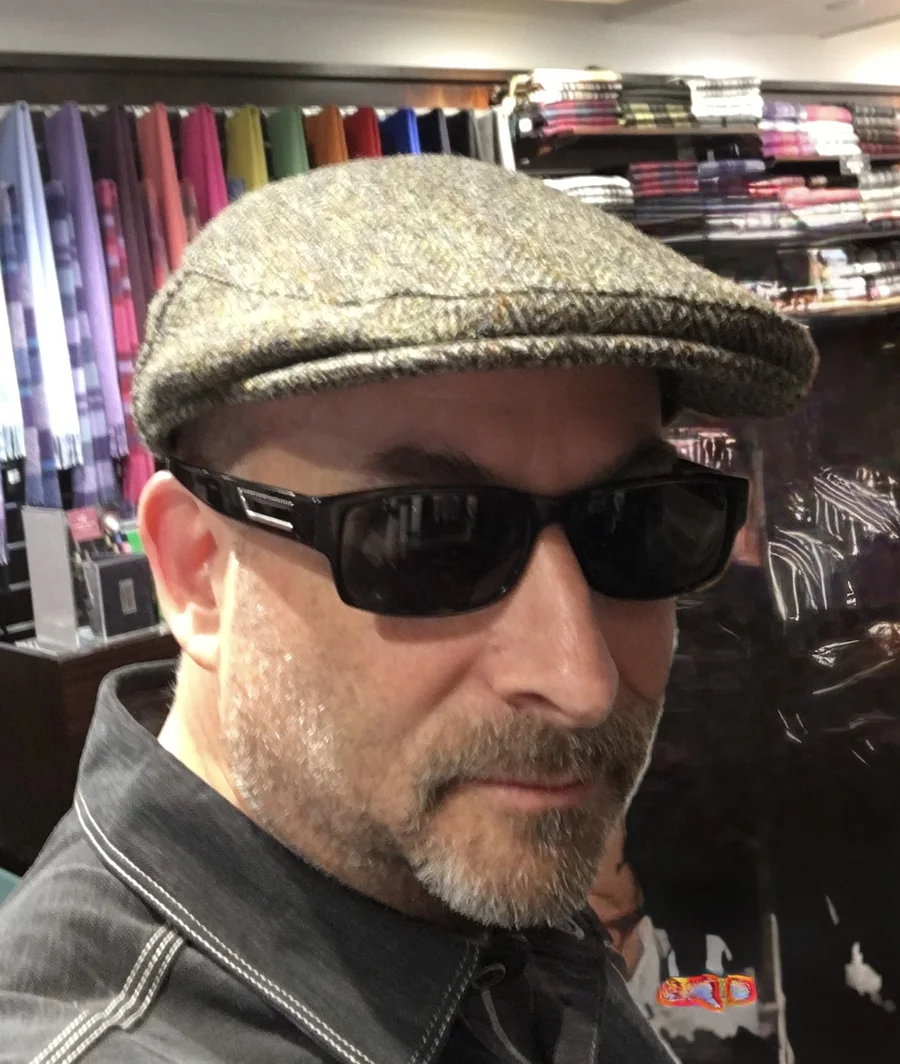 Craig L. DeLue in a tweed cap and sunglasses